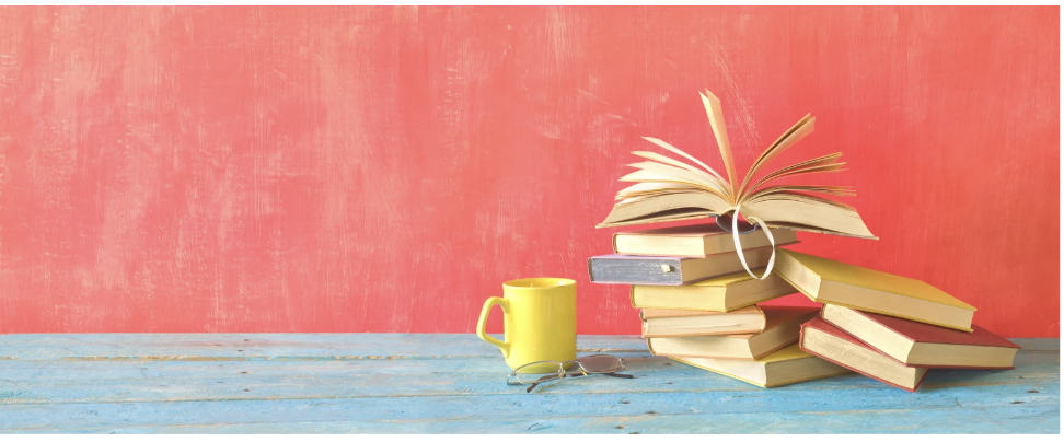 Stack of books with coffee cup